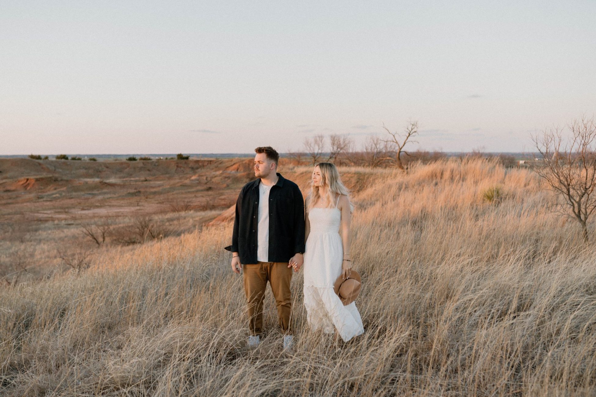 Couple Standing in a field at Gloss Mountains during golden hour
